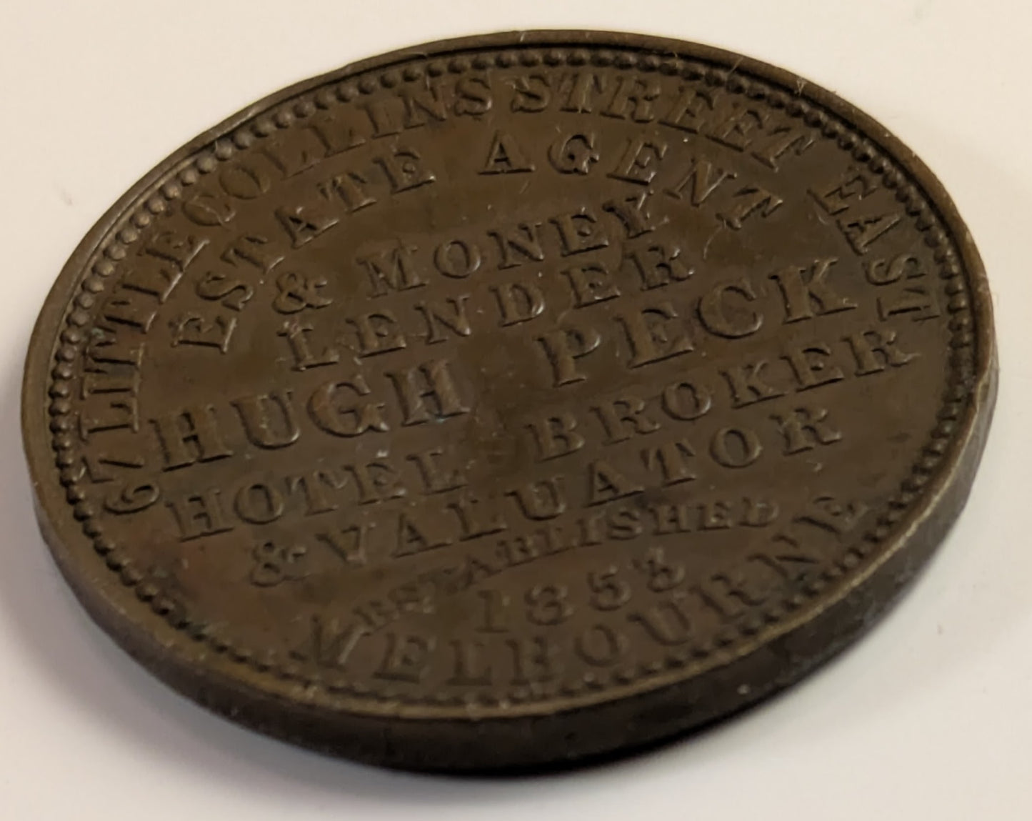 AUSTRALIA, Melbourne, Hugh Peck ~ ND ~ Penny Token ~ Long legends both sides ~ The rarer of two varieties ~ Ren-423, A-433, KM-Tn109 ~ VF, but small dent in center of obverse