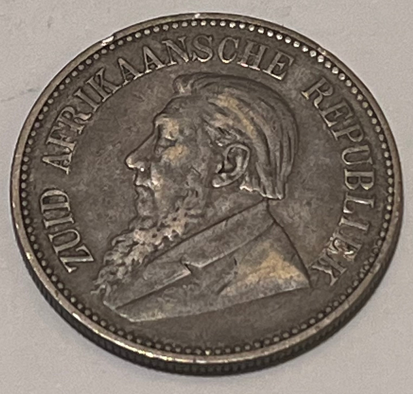SOUTH AFRICA, Zuid Afrikaansche Republiek ~ 1894 ~ 2 1/2 Shillings ~ Bust of Paul Kruger left, "ZUID AFRIKAANSCHE REPUBLIEK" ~ Flagged Arms, banner, eagle, Date and denomination around. Better date ~ Y-6, KM-7 ~ Toned VF+, rb