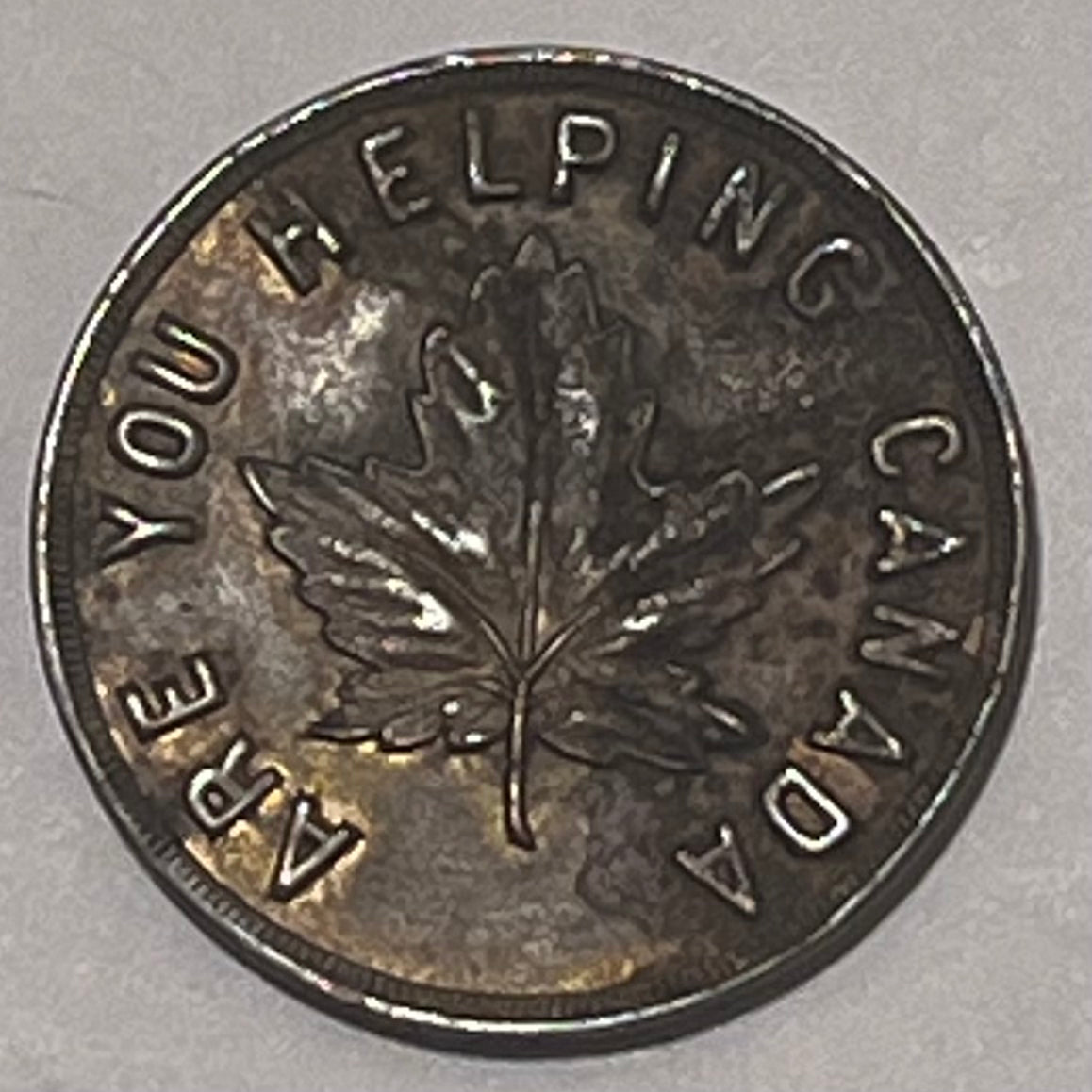 CANADA, W.H. Wilkerson ~ ND WWI era ~ Patriotic token 27mm brass ~ Arms 'Jewelry Diamonds Souvernirs W.H. Wilkerson 915 Government St. Victoria B.C.' ~ 'Are you helping Canada' around maple leaf ~ Unlisted? ~ EF