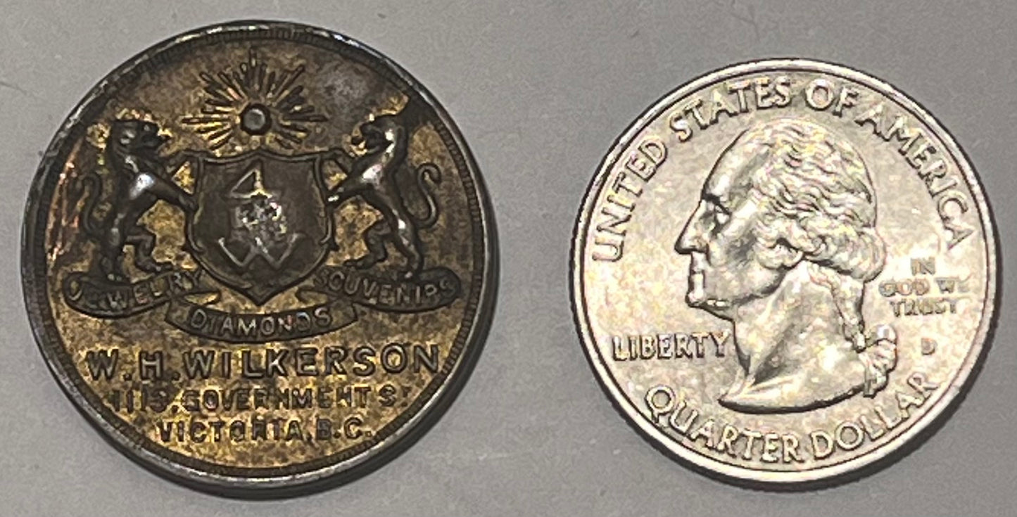 CANADA, W.H. Wilkerson ~ ND WWI era ~ Patriotic token 27mm brass ~ Arms 'Jewelry Diamonds Souvernirs W.H. Wilkerson 915 Government St. Victoria B.C.' ~ 'Are you helping Canada' around maple leaf ~ Unlisted? ~ EF