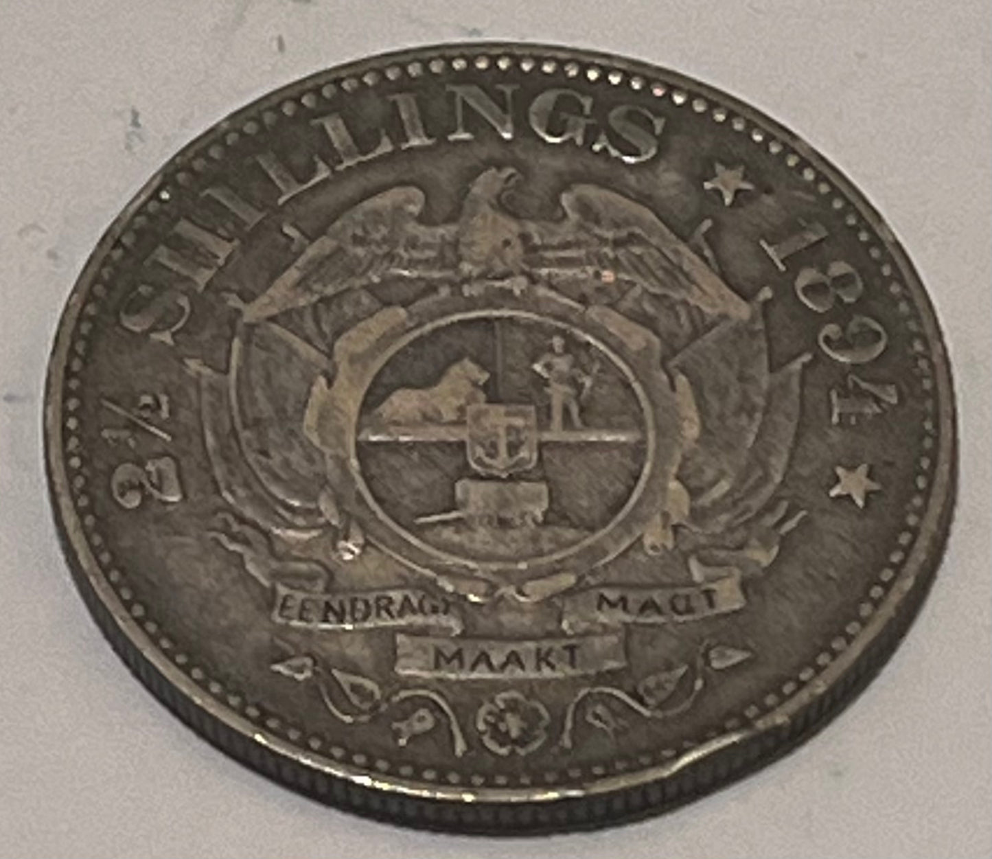 SOUTH AFRICA, Zuid Afrikaansche Republiek ~ 1894 ~ 2 1/2 Shillings ~ Bust of Paul Kruger left, "ZUID AFRIKAANSCHE REPUBLIEK" ~ Flagged Arms, banner, eagle, Date and denomination around. Better date ~ Y-6, KM-7 ~ Toned VF+, rb