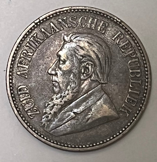 SOUTH AFRICA, Zuid Afrikaansche Republiek ~ 1894 ~ 2 1/2 Shillings ~ Bust of Paul Kruger left, "ZUID AFRIKAANSCHE REPUBLIEK" ~ Flagged Arms, banner, eagle, Date and denomination around. Better date ~ Y-6, KM-7 ~ Toned VF+, rb