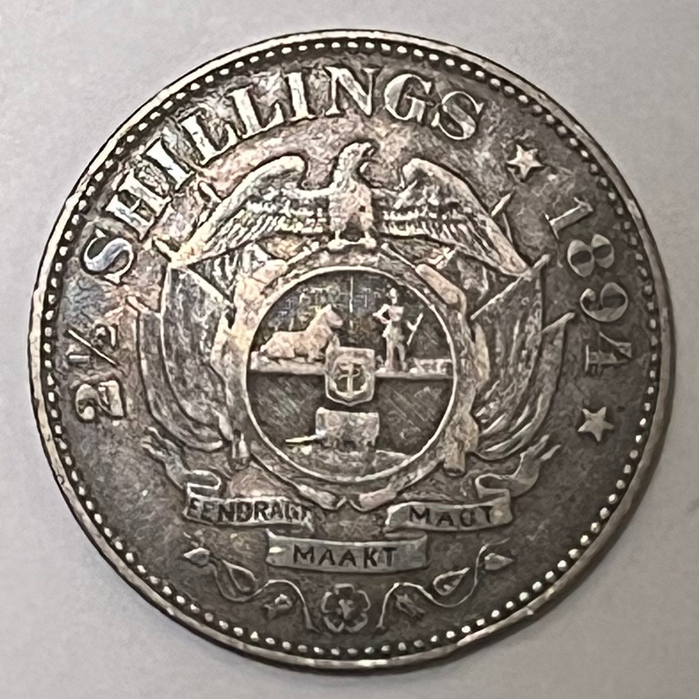 SOUTH AFRICA, Zuid Afrikaansche Republiek ~ 1894 ~ 2 1/2 Shillings ~ Bust of Paul Kruger left, "ZUID AFRIKAANSCHE REPUBLIEK" ~ Flagged Arms, banner, eagle, Date and denomination around. Better date ~ Y-6, KM-7 ~ Toned VF+, rb