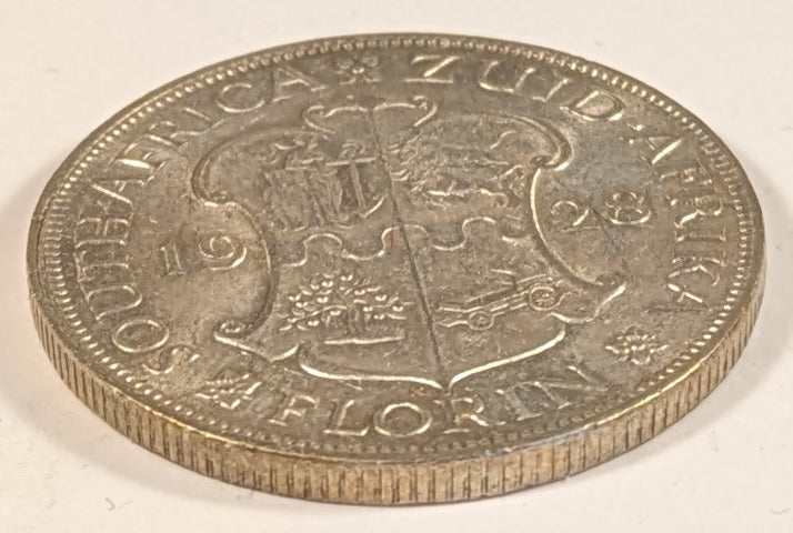 SOUTH AFRICA, Union of So. Africa, Dominion  ~ 1928 ~ 1 Florin ~ Crowned bust of George V left ~ Arms divides date. Denomination as FLORIN.  ~ Y-20, KM-18 ~ EF
