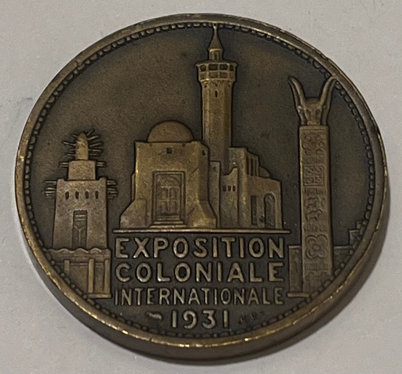 FRANCE, International Colonial Expo (Paris) ~ 1931 ~ Bronze 32mm ~ Head of Africa left "AFRIQUE" by L. Desvignes ~ View of Expo buildings "EXPOSITION COLONIALE INTERNATIONALE 1931" in 4 lines ~ EF, nicks
