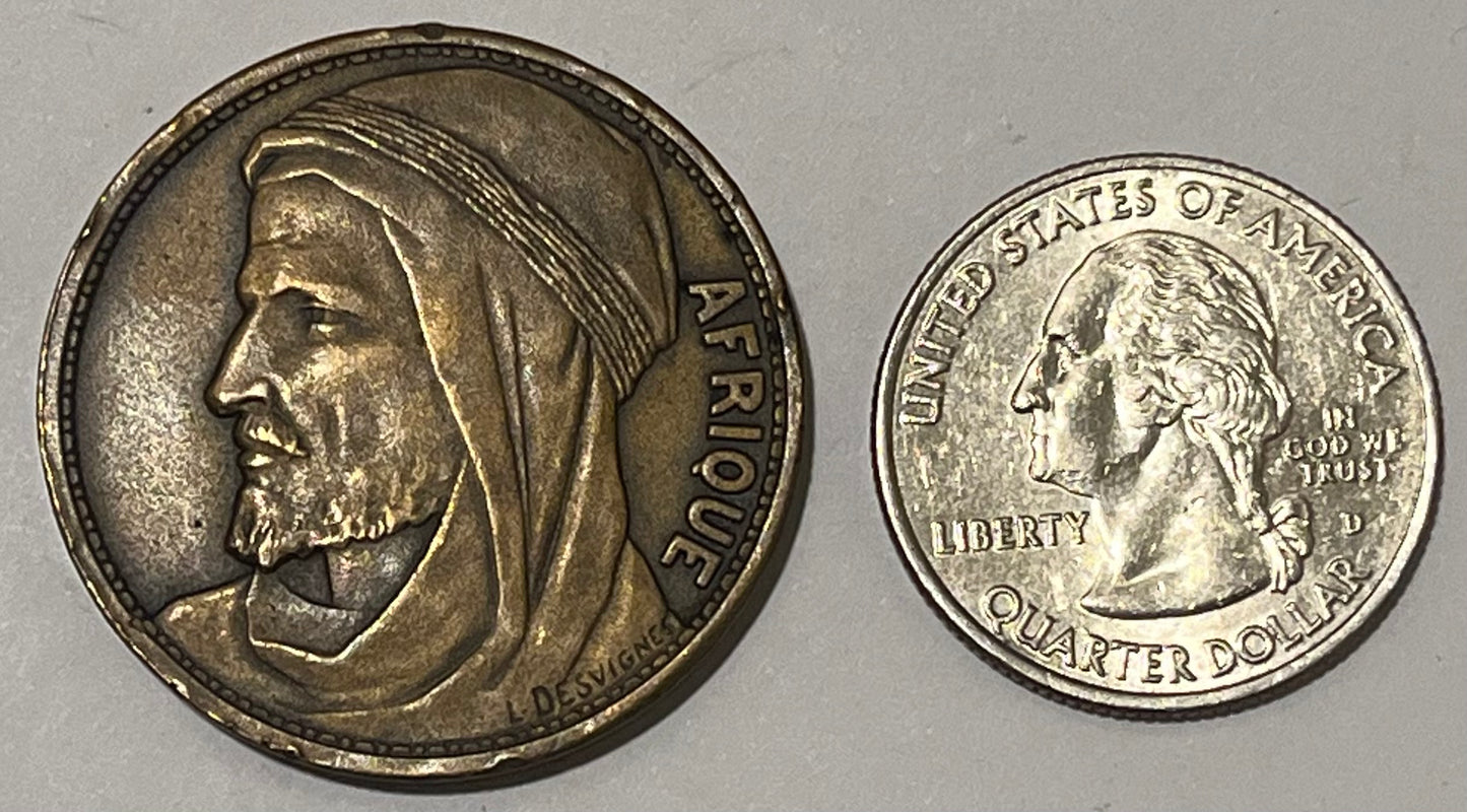 FRANCE, International Colonial Expo (Paris) ~ 1931 ~ Bronze 32mm ~ Head of Africa left "AFRIQUE" by L. Desvignes ~ View of Expo buildings "EXPOSITION COLONIALE INTERNATIONALE 1931" in 4 lines ~ EF, nicks