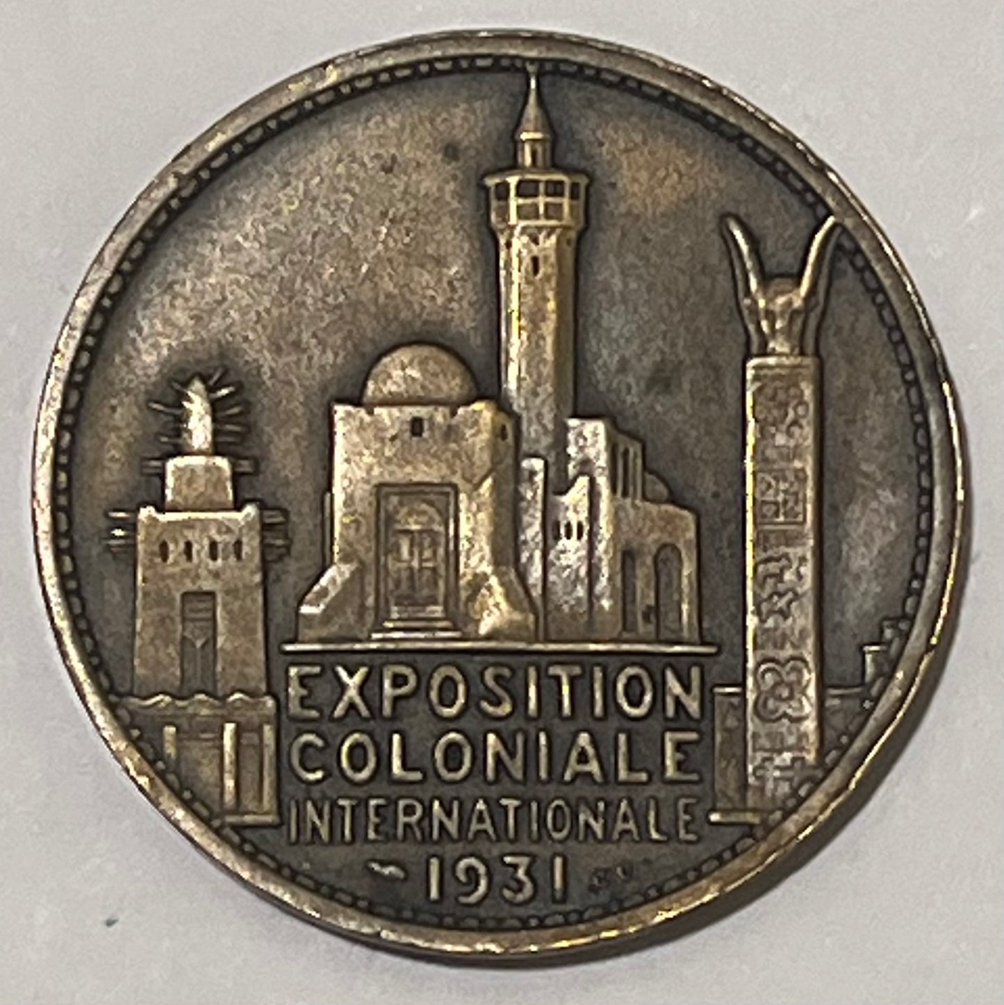 FRANCE, International Colonial Expo (Paris) ~ 1931 ~ Bronze 32mm ~ Head of Africa left "AFRIQUE" by L. Desvignes ~ View of Expo buildings "EXPOSITION COLONIALE INTERNATIONALE 1931" in 4 lines ~ EF, nicks