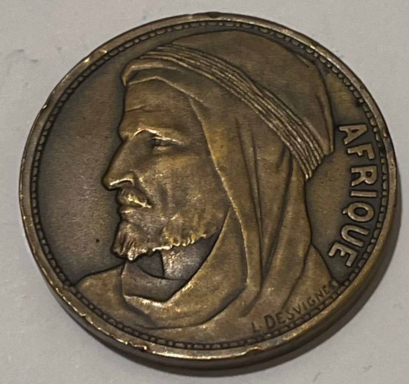 FRANCE, International Colonial Expo (Paris) ~ 1931 ~ Bronze 32mm ~ Head of Africa left "AFRIQUE" by L. Desvignes ~ View of Expo buildings "EXPOSITION COLONIALE INTERNATIONALE 1931" in 4 lines ~ EF, nicks