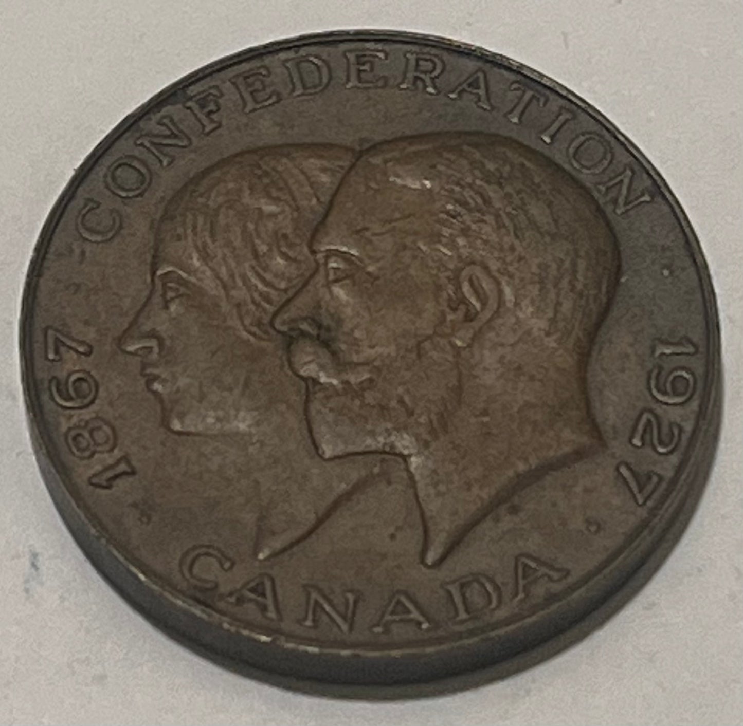 CANADA, 60th Anniversary of Confederation ~ 1927 ~ AE27 ~ Conjoined busts of George V and Mary left ~ Arms ~ TC-234773 ~ EF+