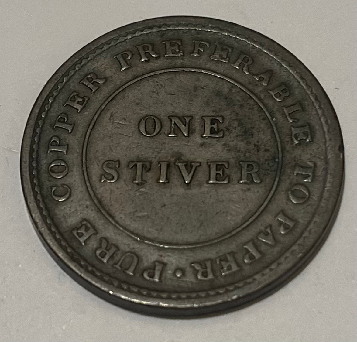 BRITISH GUIANA, Private Token Coinage ~ 1838 ~ Stiver ~ female seated on bale of hay left. Issued by Mr. Balgarmie a dry goods merchant ~ PURE COPPER PREFERABLE TO PAPER around 1 STIVER ~ KM-TN1, Pridore-60, Rulau ~ F-VF