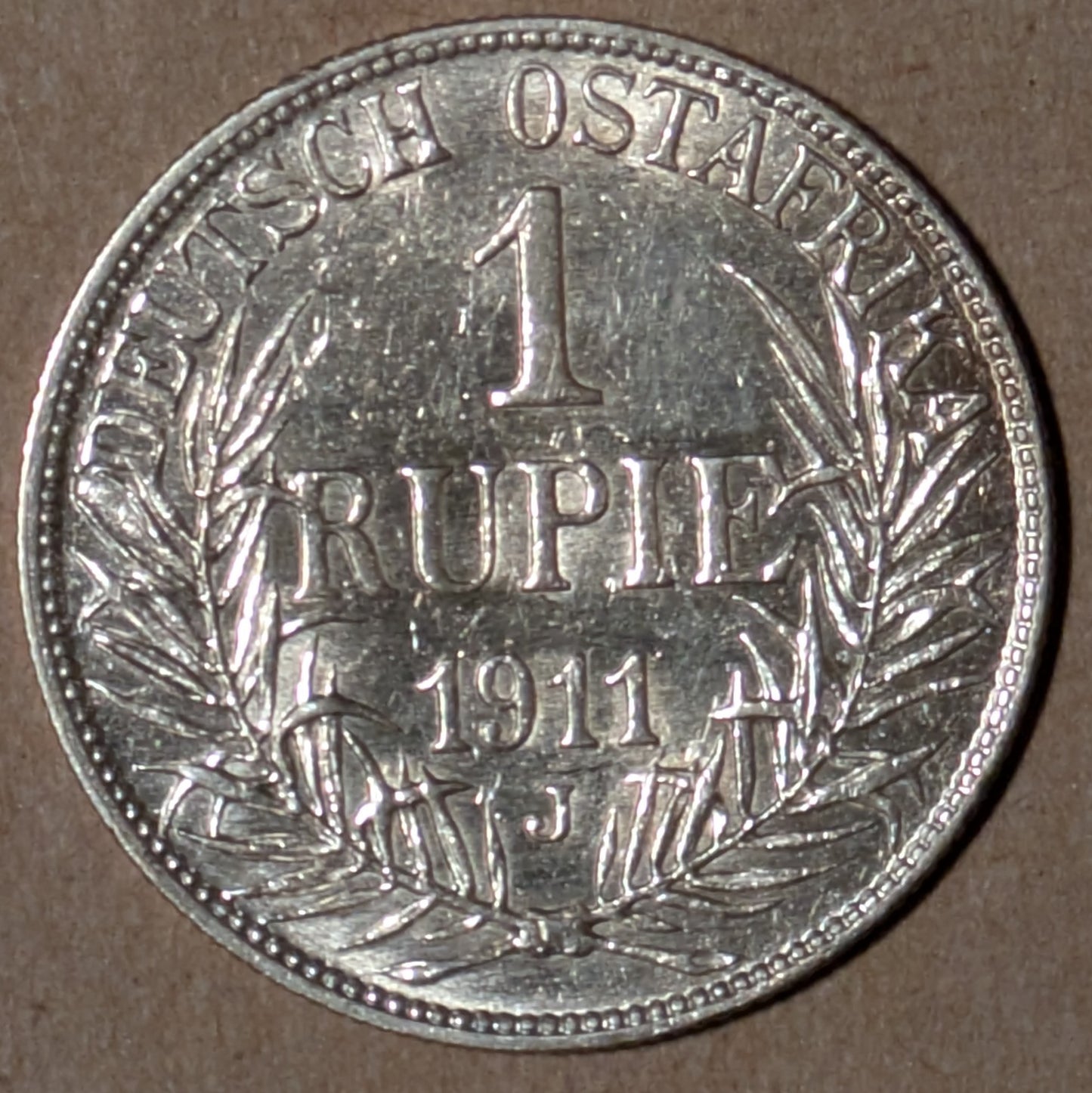 GERMAN EAST AFRICA, German East Africa Company ~ 1911-J ~ Rupie of Hamburg ~ Helmeted bust left ~ Demonimation, date and mintmark within wreath and legend ~ Y-15, KM-10 ~ Ch. AU, lightly brushed