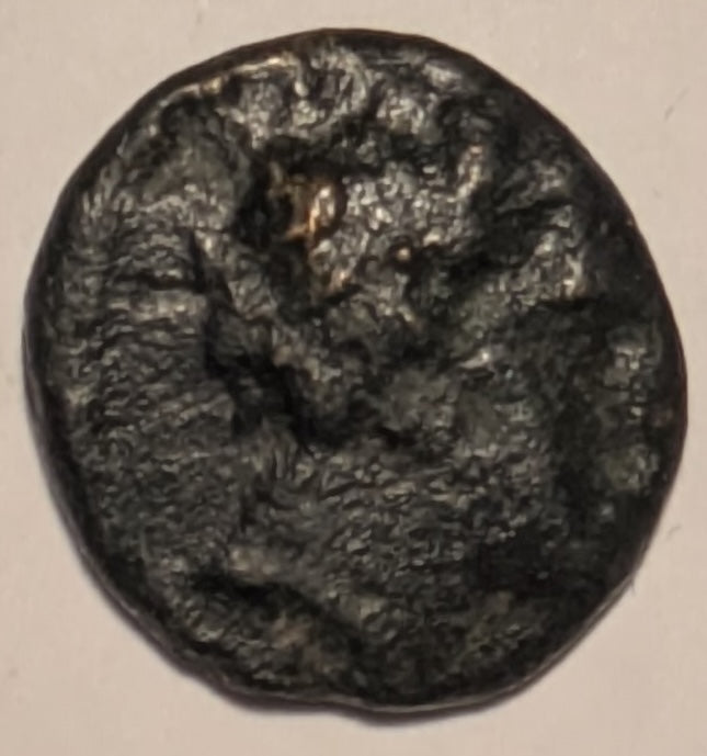 THESSALY, Peumata ~ c. 300-286 BC ~ Æ13 (1.34g) ~ Head of a nymph right, wearing wreath of oak  ~ Monogram ~ Thessalian helmet right. Rare, seldom seen locale and coin.  ~ SNG Cop-198,  Rogers 442. ~ aV