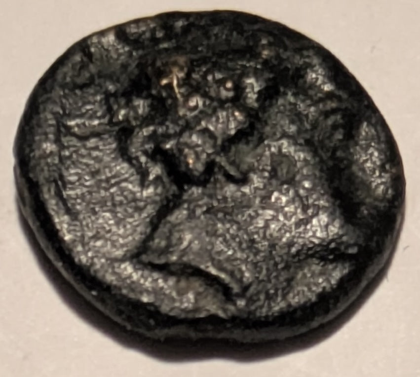 THESSALY, Peumata ~ c. 300-286 BC ~ Æ13 (1.34g) ~ Head of a nymph right, wearing wreath of oak  ~ Monogram ~ Thessalian helmet right. Rare, seldom seen locale and coin.  ~ SNG Cop-198,  Rogers 442. ~ aV